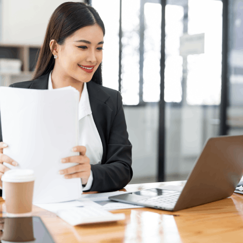 An expert reviews a balance sheet in a secure office while Translation Services in Bellevue handle financial documents.