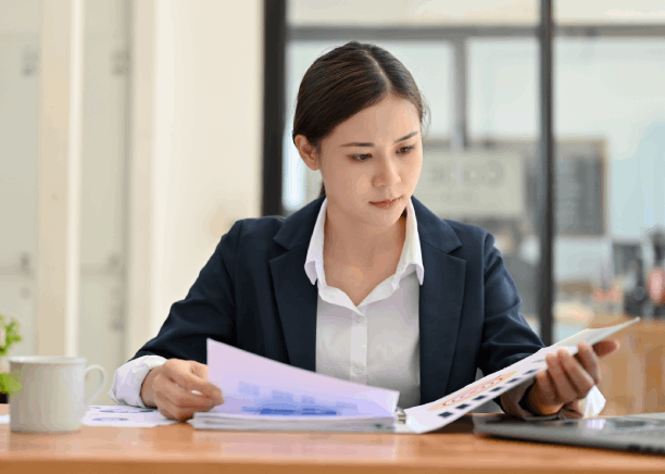 A certified translator compares Spanish and English pages as Translation Services in Burien prepare common language filings.