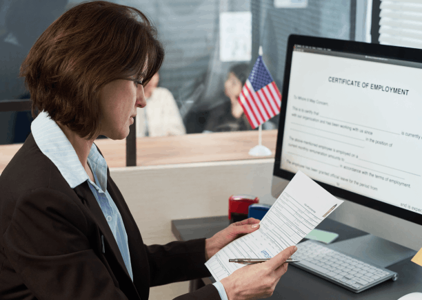 A client reviews a certified personal document packet for Translation Services in Renton, ready for agency submission.