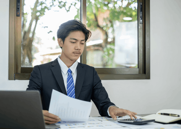 An auditor compares Chinese and English ledgers using Chinese Translation Services in Washington for financial audit.
