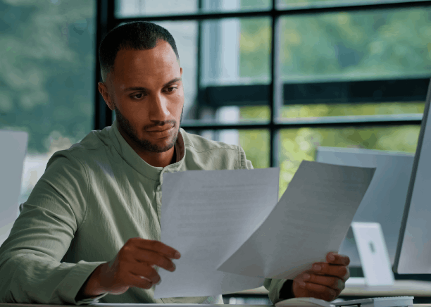 A project manager checks an NDA and access log while Translation Services in Kirkland translate financial statements.