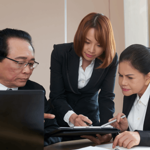 A finance team reviews translated investor slides as Vietnamese Translation Services in Washington support global business.