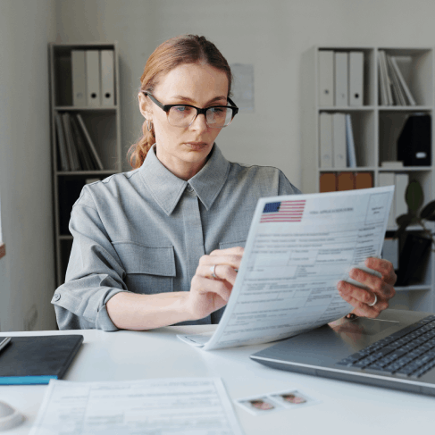 A reviewer checks names and dates as Translation Services in Kirkland finalize expedited immigration document translations.