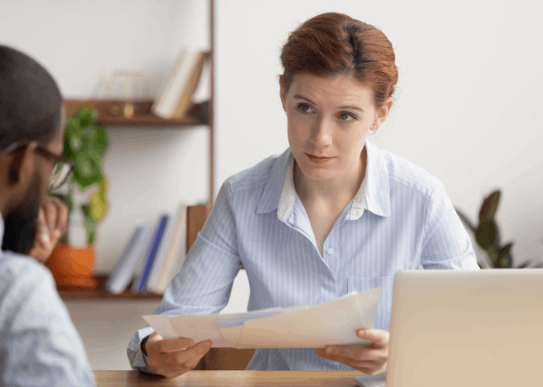 A translator compares a bilingual contract line by line while Translation Services in Redmond ensure legal business accuracy.