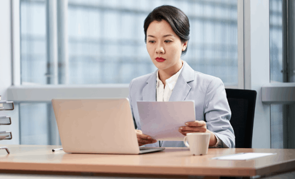 A translator reviews a contract at a desk, providing Translation Services in Redmond for legal document needs.