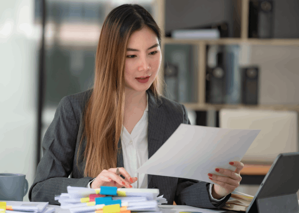 A translator compares a marriage certificate to its translation as Translation Services in Redmond verify personal document.