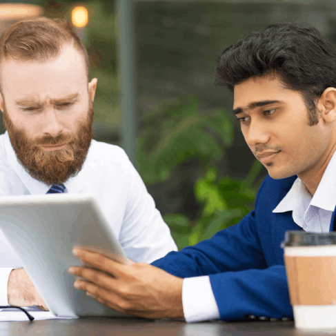 Two colleagues compare source and target pages with Translation Services in Renton, completing a business accuracy review.