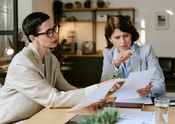 A closing agent compares a translated property deed with the original, using Translation Services in Renton for legal review.