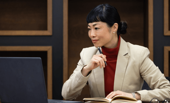 A translator works on an encrypted laptop, delivering secure Vietnamese Translation Services in Washington for local clients.