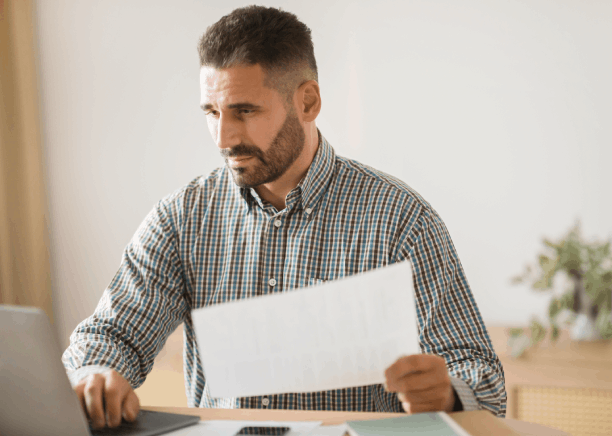 A project manager compares Spanish and English emails, using Spanish Translation Services in Washington for clients.