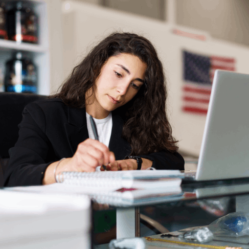 A reviewer checks a USCIS-certified English translation while Translation Services in Redmond compare it to the original.