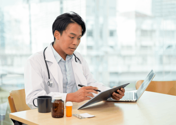A doctor checks lab results and notes while Vietnamese Translation Services in Washington handle medical records.