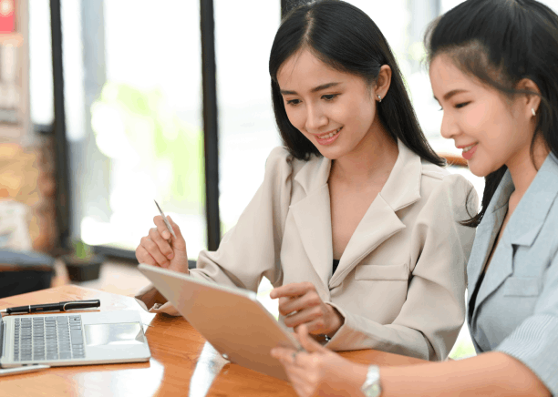 Two translators review a bilingual contract using Chinese Translation Services in Washington for business negotiations.