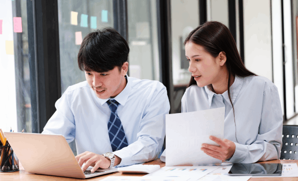 Two translators secure documents for Chinese Translation Services in Washington, handling confidential reviews for agencies.